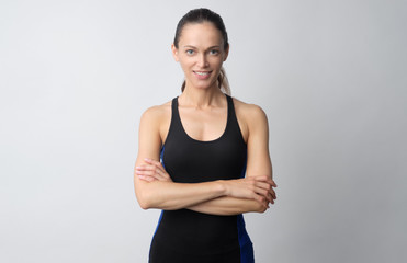 portrait of a young fitness woman in sportswear posing isolated