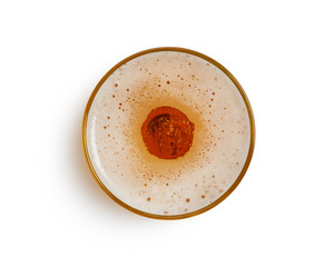 top view of beer bubbles in glass cup on white background. with clipping path.