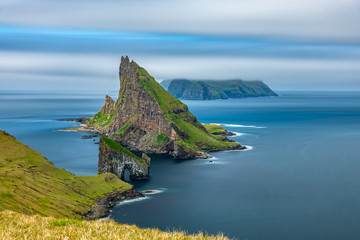 Amazing top view long exposure of Drangarnir gate in front of Tindholmur, Faroe Islands