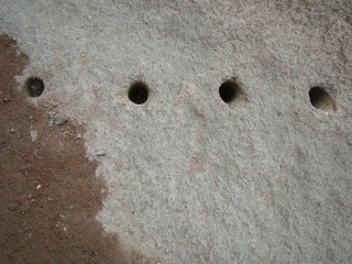 Granite stone with round holes for installing dynamite.