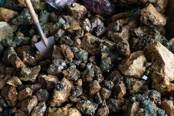 Mining. A miniature shovel and pieces of minerals with crystals.