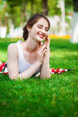 Gorgeous young pretty woman relaxing in summer park