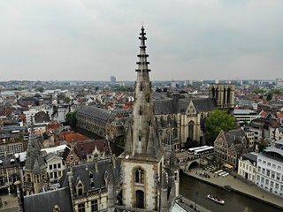 Fototapeta premium Amazing view from above. Small and comfortable town Gent. Medieval history around you.Must see for all explorer. View from Drone. From Belgium with Love. Clock tower.
