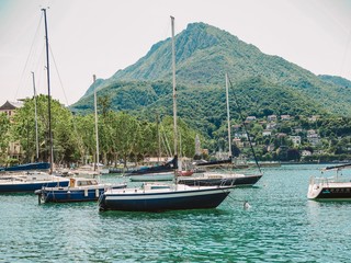 Fototapeta na wymiar Parked yachts and boats on lake Como