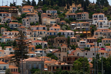 Fototapeta na wymiar View to white houses with red roofs of Poros town, Saronic islands, Poros island, Greece. Pattern