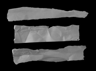 Obraz premium White paper scraps isolated on black background and texture