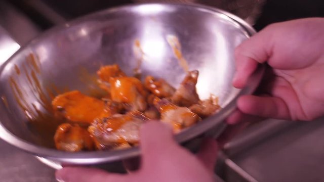 Mixing suace with chicken tenders in slow motion