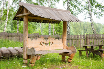 Carved wooden bench, commonly used in rural areas.