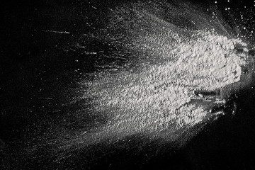 White powder isolated on black background, top view with clipping path