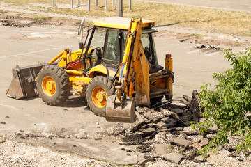 Tractor Dismantles Asphalt