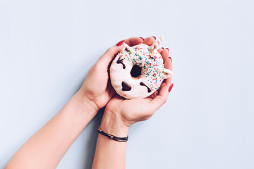 Unicorn donut in female hand