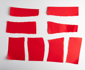 various blank pieces of red paper on white background