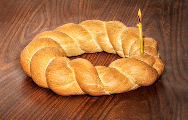 Wicker bread and a burning candle