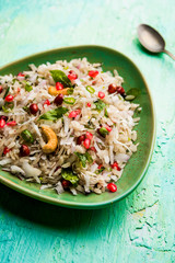 Dapde Pohe is a typical Maharashtrian breakfast, made with thin variety of poha and fresh coconut with chilli, peanuts and nuts. served in a bowl or plate. selective focus