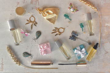 Make up accessories, bijouterie, mascara on a white wooden table. Beauty cosmetics and perfumes concept.