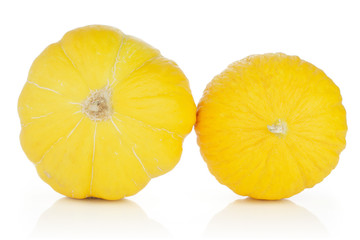Group of two whole ribbed fresh yellow melon canary isolated on white background