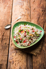 Dapde Pohe is a typical Maharashtrian breakfast, made with thin variety of poha and fresh coconut with chilli, peanuts and nuts. served in a bowl or plate. selective focus