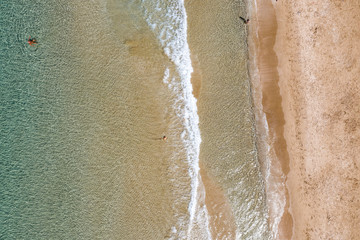 Fototapeta na wymiar Sandy seashore with small waves.