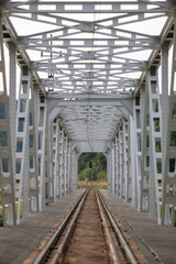 A metal train bridge with nature in the distance_2