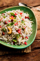 Dapde Pohe is a typical Maharashtrian breakfast, made with thin variety of poha and fresh coconut with chilli, peanuts and nuts. served in a bowl or plate. selective focus