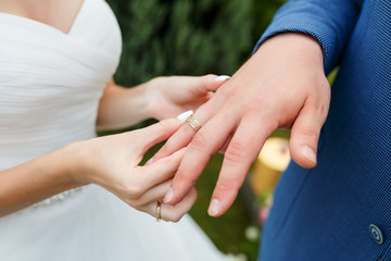 Newlyweds put each other rings on the ceremony