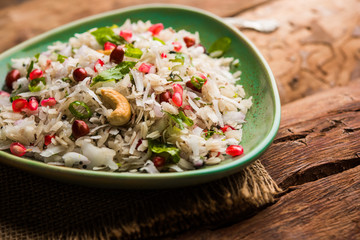 Dapde Pohe is a typical Maharashtrian breakfast, made with thin variety of poha and fresh coconut with chilli, peanuts and nuts. served in a bowl or plate. selective focus