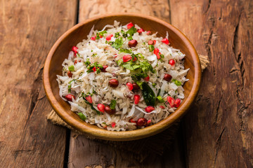 Dapde Pohe is a typical Maharashtrian breakfast, made with thin variety of poha and fresh coconut with chilli, peanuts and nuts. served in a bowl or plate. selective focus