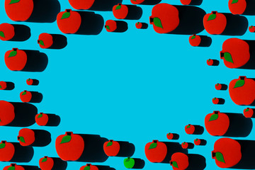 Pattern of red and single green toy apples with place for your text. Healthy eating concept. Perfect for the needs of a pediatric doctor etc.