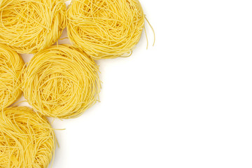 Group of five whole raw pasta angel hair copyspace on right flatlay isolated on white background