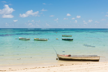 Boats on coastline on background of horizon line.