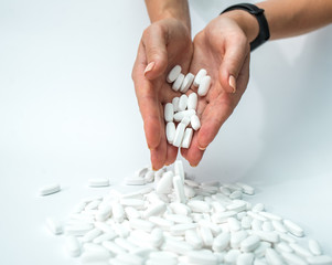 pills in hand isolated on white