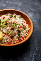 Dapde Pohe is a typical Maharashtrian breakfast, made with thin variety of poha and fresh coconut with chilli, peanuts and nuts. served in a bowl or plate. selective focus