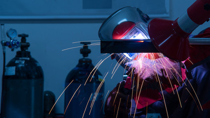 Welder in the factory,Worker with protective mask welding metal industry.
