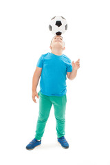 Full length portrait of a child in sportswear jogging with a soccer ball. Isolated on white background