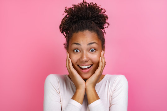 Closeup portrait of a pretty girl over pink background with amazed emotion on face - Image
