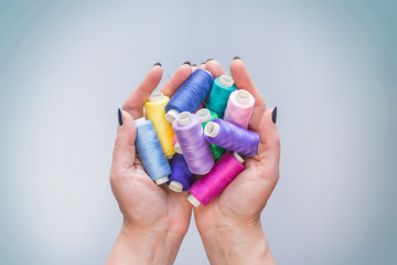 a set of threads for sewing of different colors to hold in the hands of a tailor