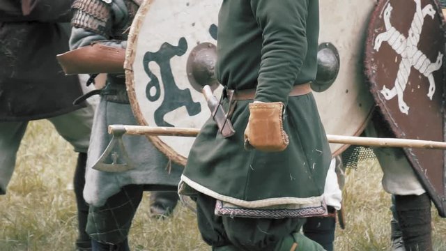 Viking warrior with axe. Medieval soldiers in full armor, shield wall, preparing for battle