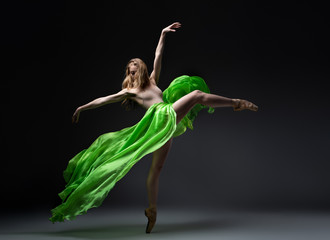 female ballet dancer in green skirt in wind movement