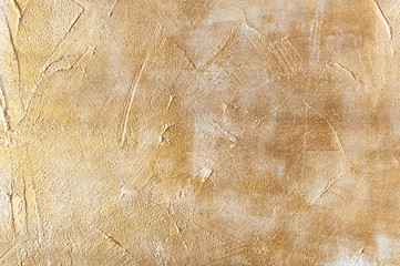 Grunge concrete handpainted background in gold