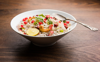 Dapde Pohe is a typical Maharashtrian breakfast, made with thin variety of poha and fresh coconut with chilli, peanuts and nuts. served in a bowl or plate. selective focus