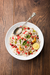 Dapde Pohe is a typical Maharashtrian breakfast, made with thin variety of poha and fresh coconut with chilli, peanuts and nuts. served in a bowl or plate. selective focus