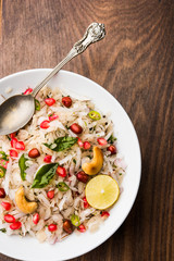 Dapde Pohe is a typical Maharashtrian breakfast, made with thin variety of poha and fresh coconut with chilli, peanuts and nuts. served in a bowl or plate. selective focus