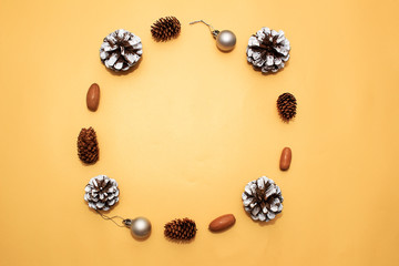Christmas holidays composition on golden paper background. Craft boxes of gifts, wooden deer and snowflakes, fir cones, pine cones. Concept of happy (marry) christmas card. 