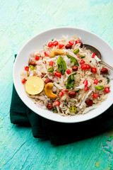 Dapde Pohe is a typical Maharashtrian breakfast, made with thin variety of poha and fresh coconut with chilli, peanuts and nuts. served in a bowl or plate. selective focus