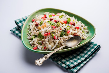 Dapde Pohe is a typical Maharashtrian breakfast, made with thin variety of poha and fresh coconut with chilli, peanuts and nuts. served in a bowl or plate. selective focus