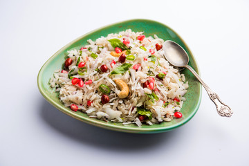 Dapde Pohe is a typical Maharashtrian breakfast, made with thin variety of poha and fresh coconut with chilli, peanuts and nuts. served in a bowl or plate. selective focus