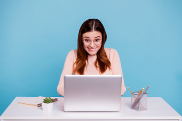 Close up photo beautiful she her foxy lady sit desk office workplace workstation unexpected investment startup excellent mark exam wear casual pastel warm pullover isolated bright blue background