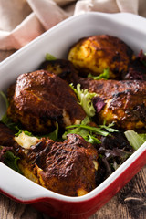 Roasted tandoori chicken with basmati rice on wooden table