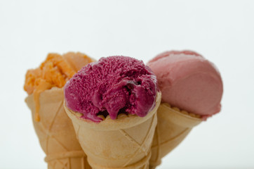 Assortment of fruity ice cream on cones
