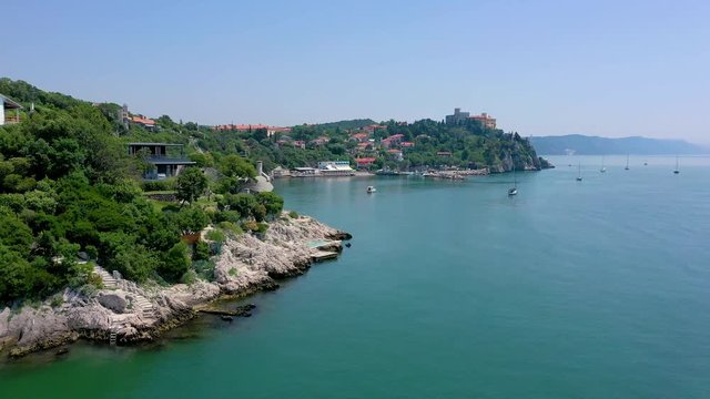 Sea shore near Trieste, Italy. Aerial drone view of ruines of the old fortress of Duino Castle.